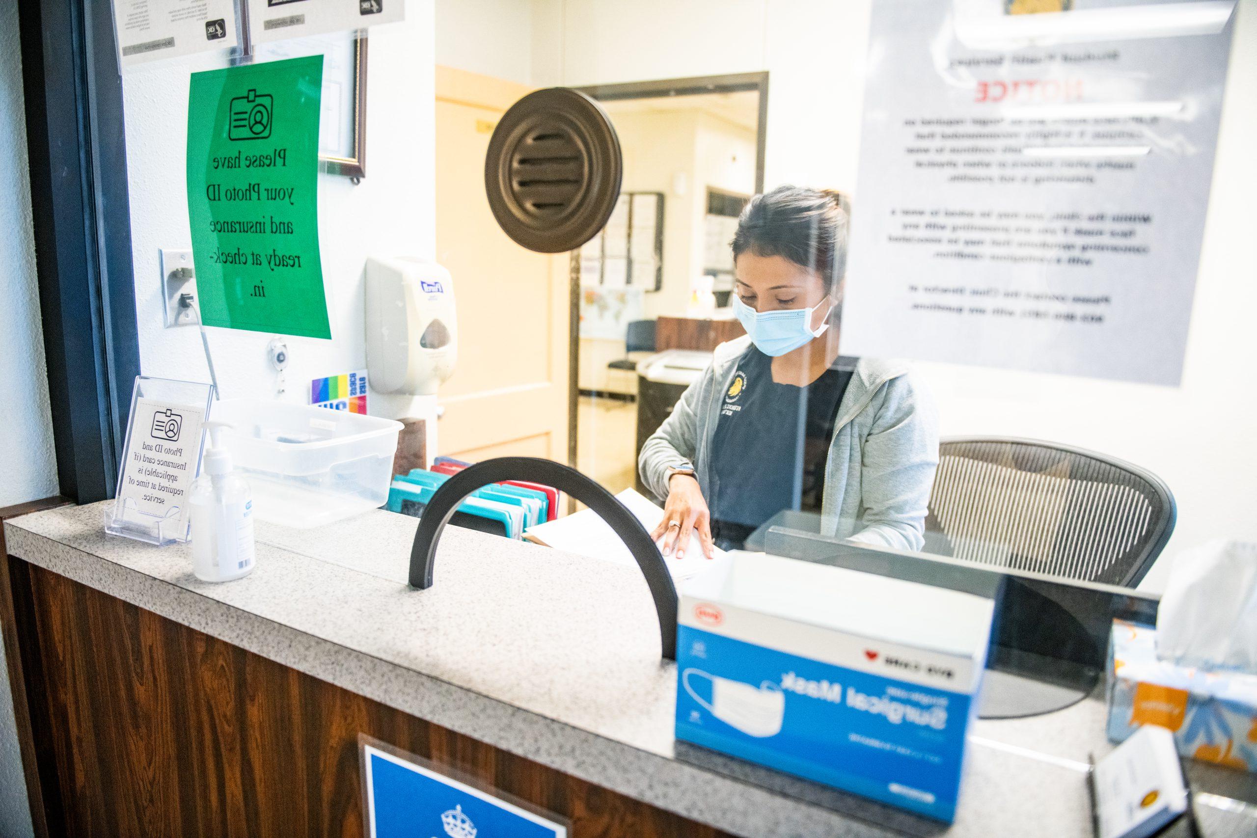 A female nurse at the reception area.